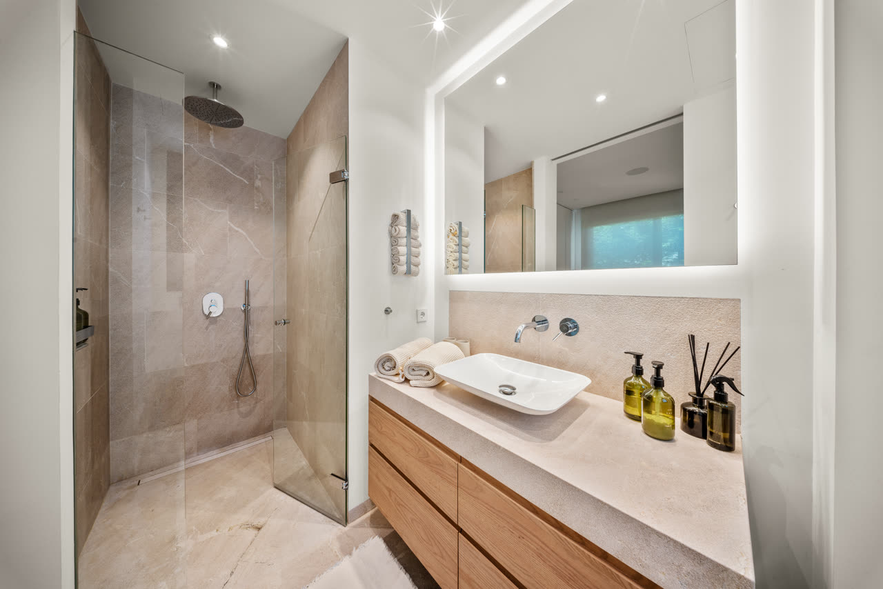 Guest bathroom with backlit stone vanity